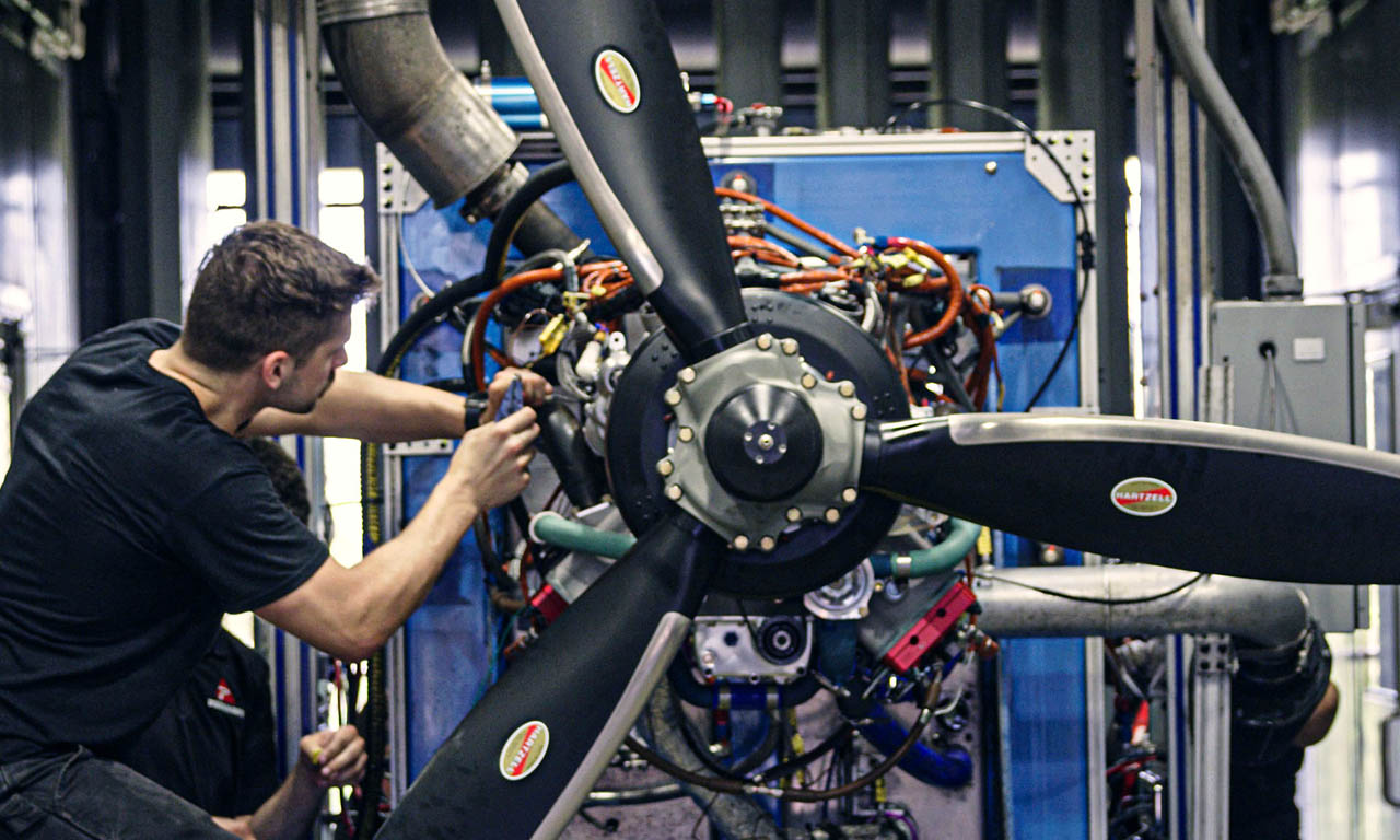 technician working on propeller of engine